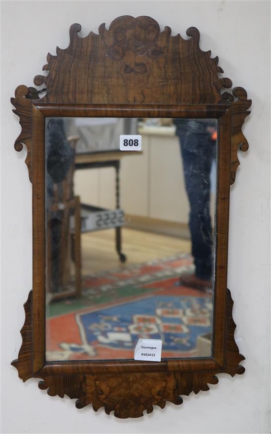 A George I style walnut fret cut wall mirror W.36cm